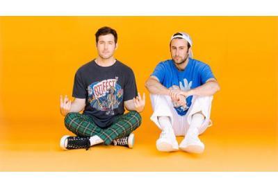 DJ/Producer duo Two Friends in front of orange background